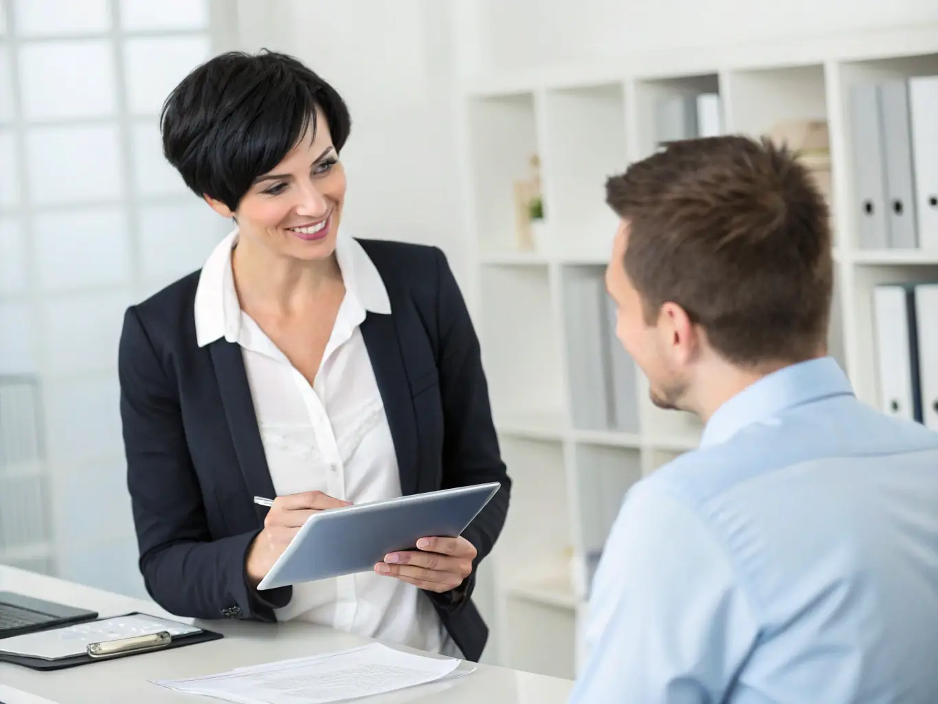 A professional consultant in a modern office setting, reviewing strategic plans with a client, emphasizing collaboration and forward-thinking.